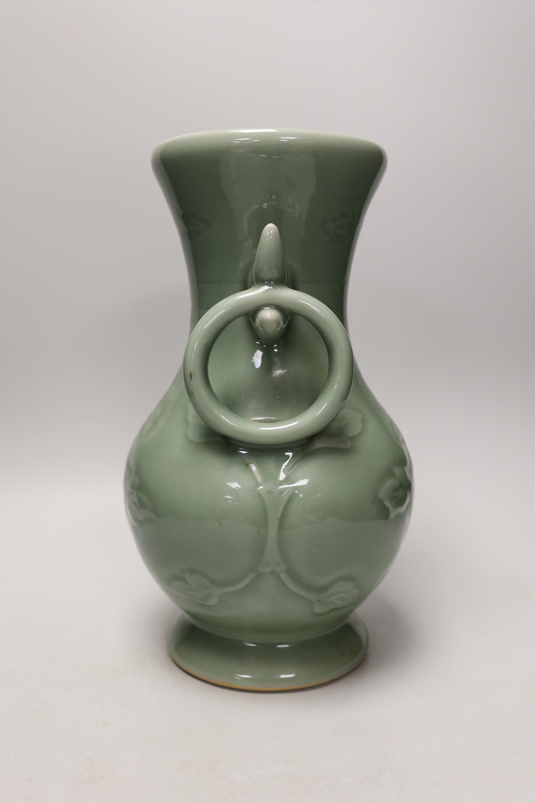 A two handled Chinese celadon glazed vase. 32cm tall